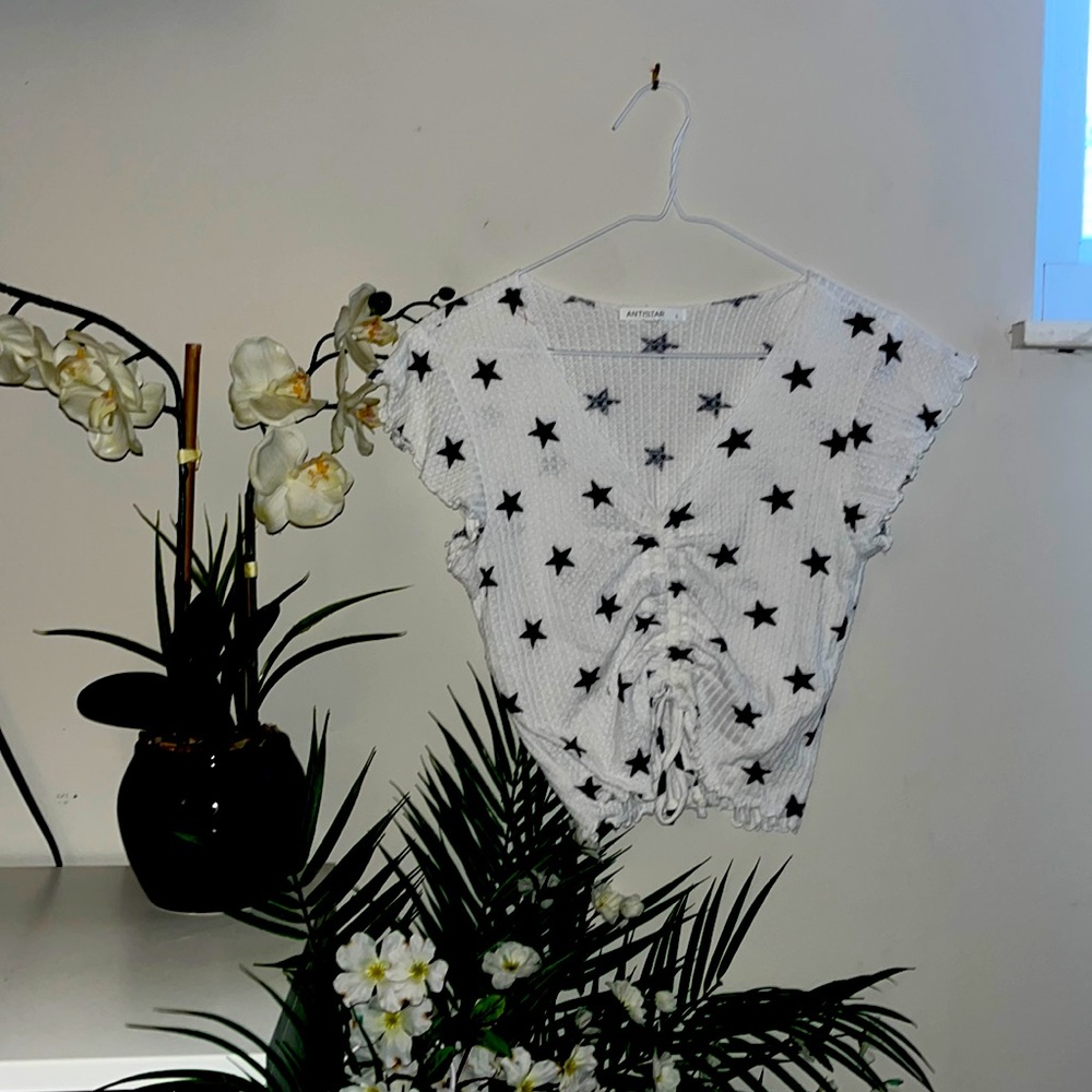 ANTISTAR size large cropped tee with ruffles.
